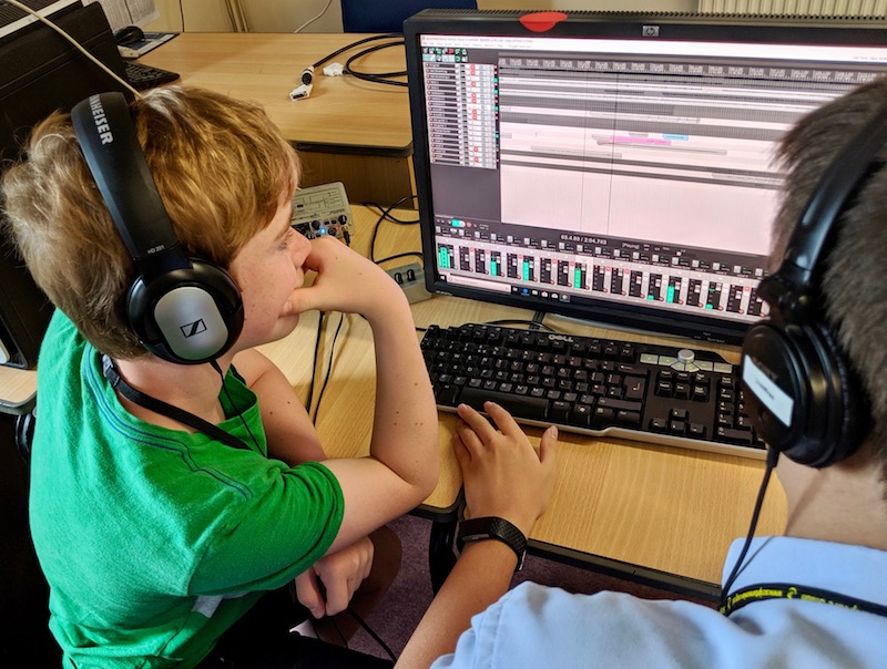 Two kids mixing a recording