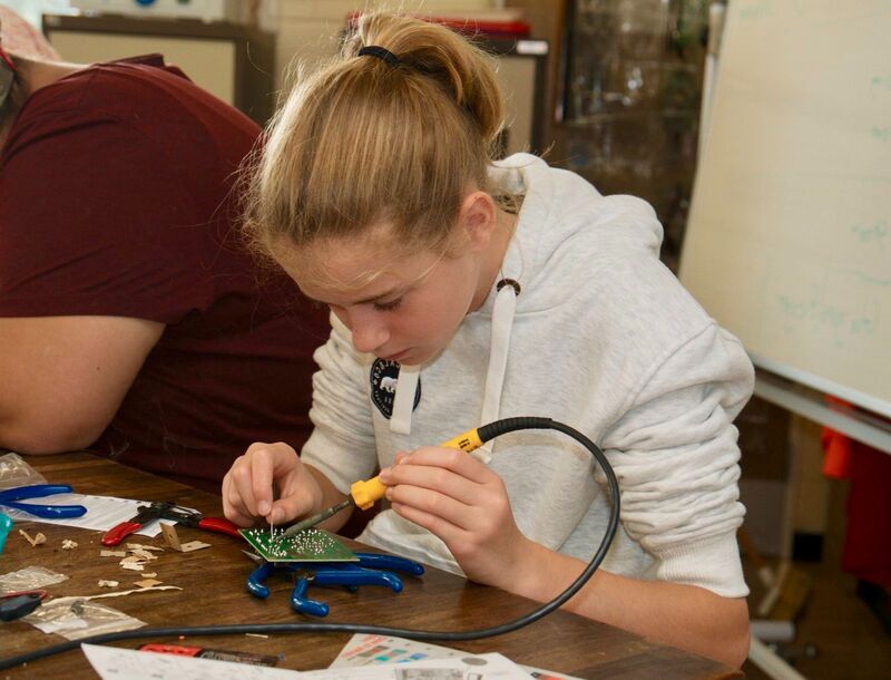 Girl holding soldering iron